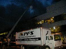 Carpet too heavy and large to fit in the passenger elevators of the building being lifted by crane to the roof for installation in a corporate client's new space located on the top floor.